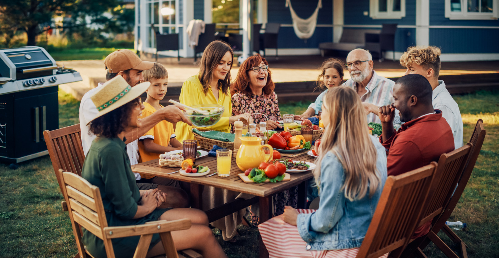 a family sits at a table laughing