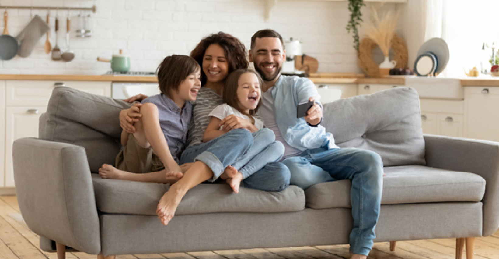 a family sits on their couch