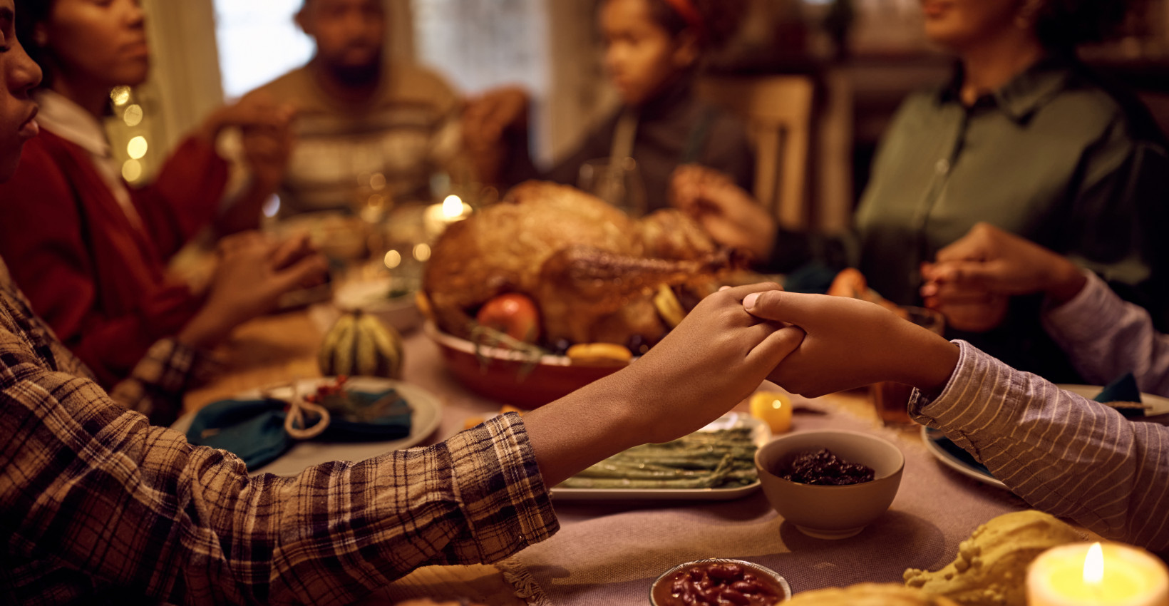 a family sits around the table for a holiday meal
