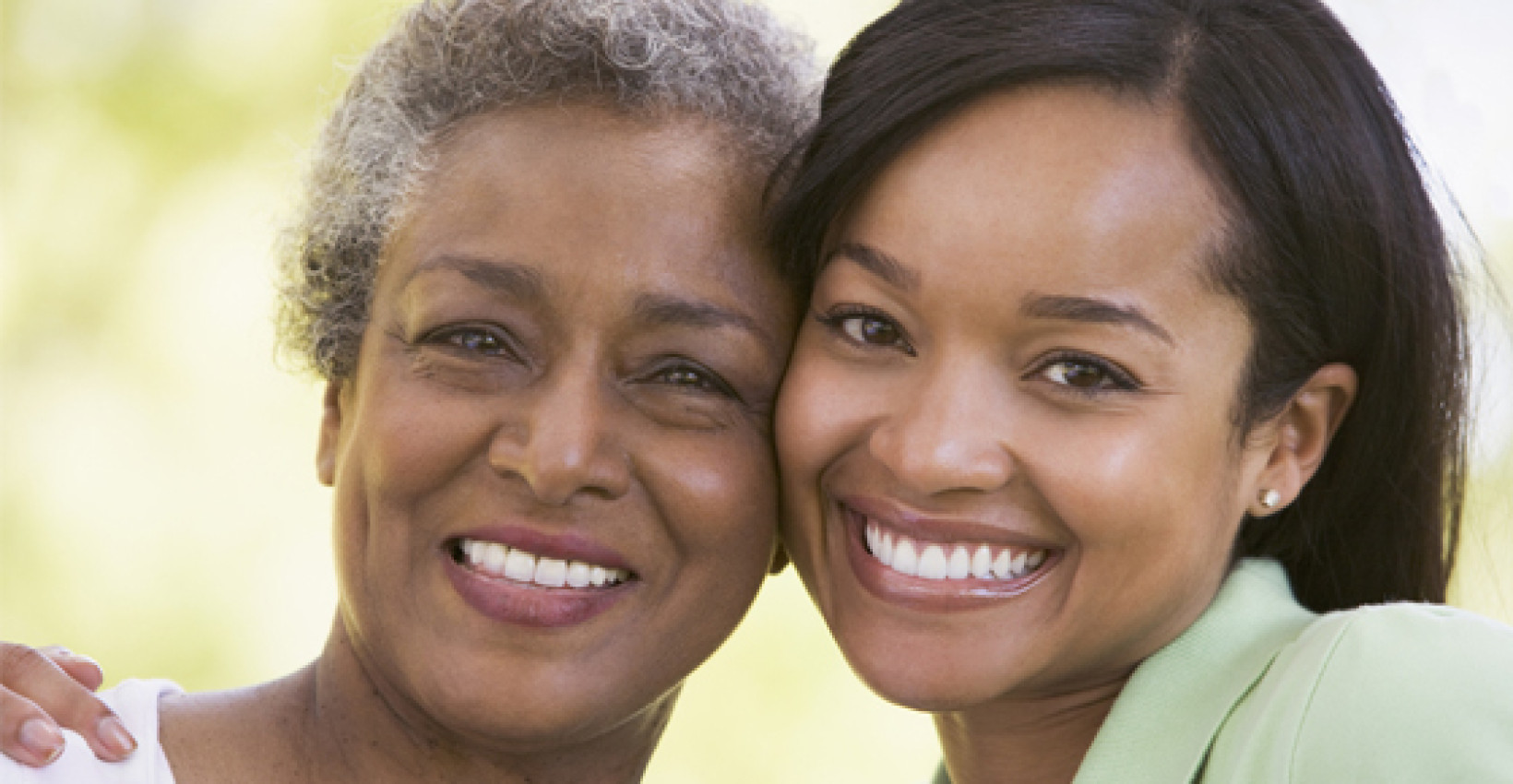 a mother and daughter stand cheek to cheek