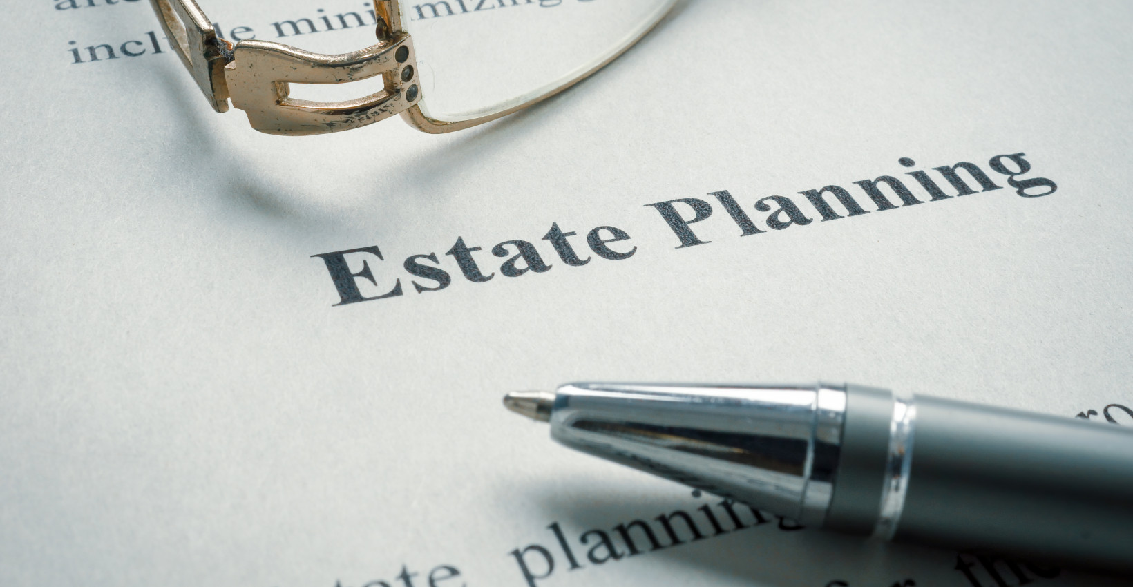 a pen next to a paper that says estate planning