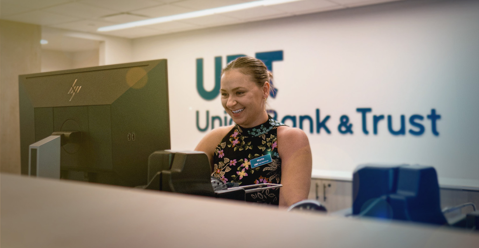 Union Bank Place Branch Manager Marta smiles at her computer
