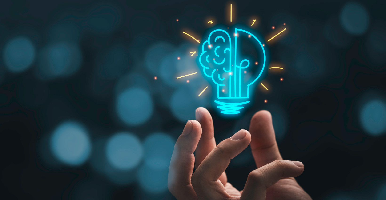 a hand hovering below a blue light bulb