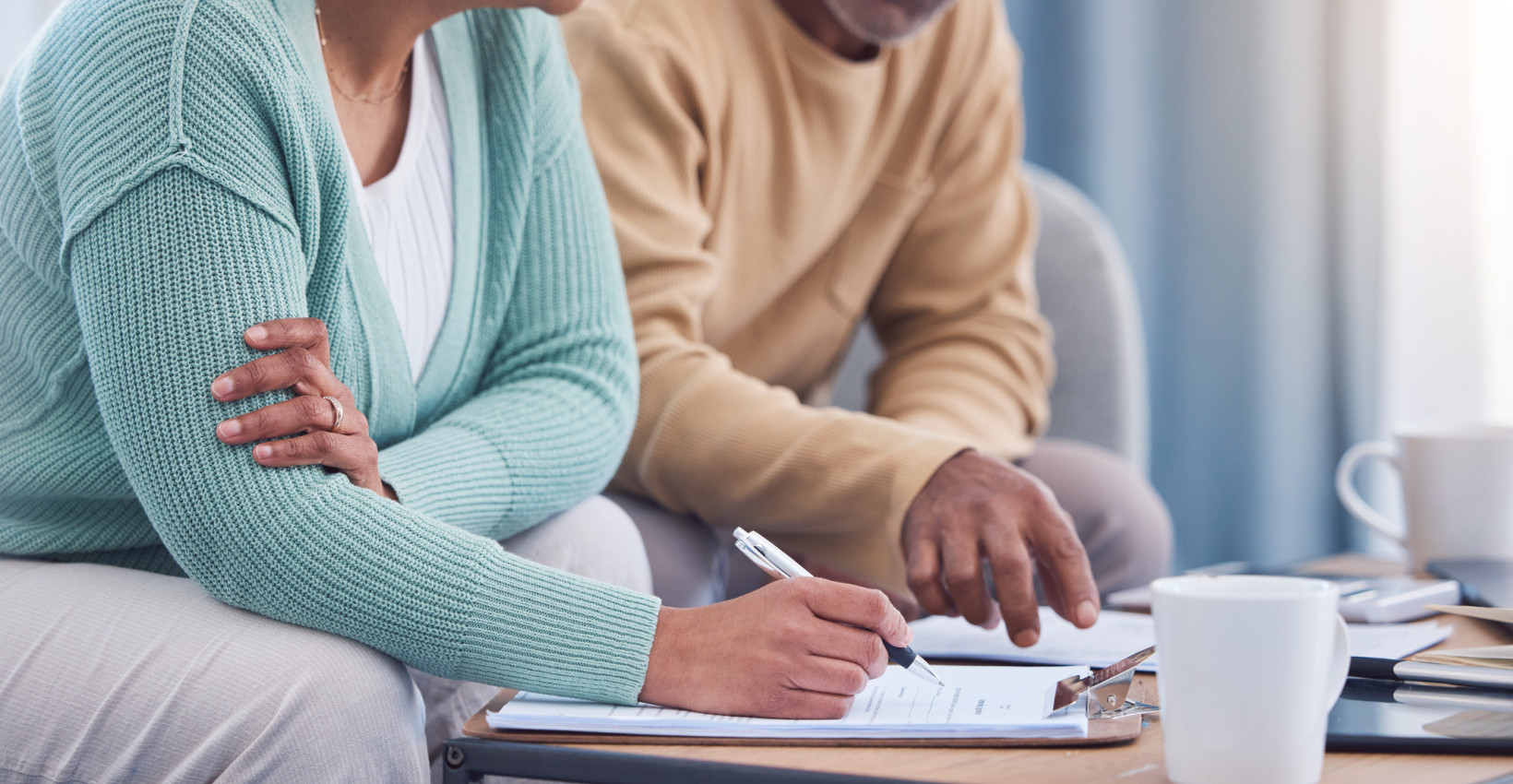 a couple sit down together to review papers