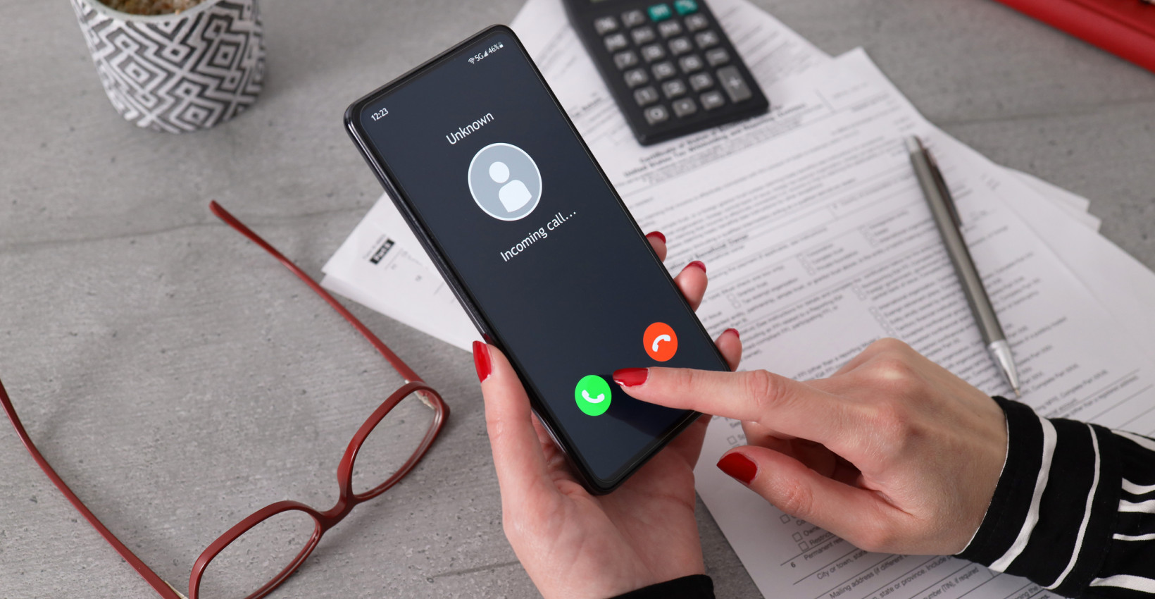 a person holds a phone that is showing an incoming call