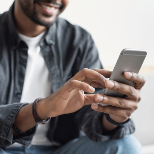 Man smiling at their phone