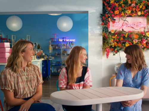 Three female entrepeneurs being interviewed in a small shop. 