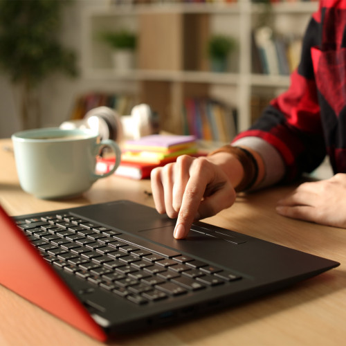 Someone using their finger to click on a laptop