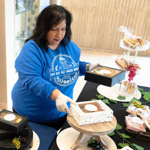 Fay in her pop up shop at Union Bank Place placing desserts