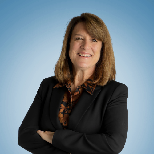 leslie gibbens headshot on a blue background
