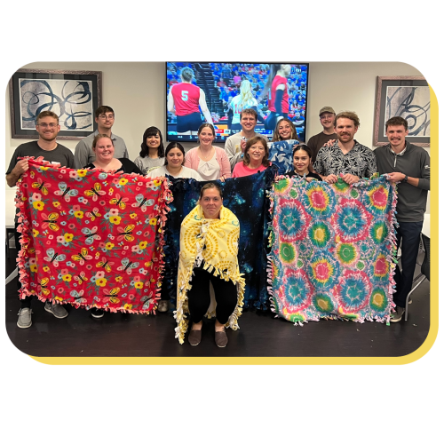 a group of people hold up blankets