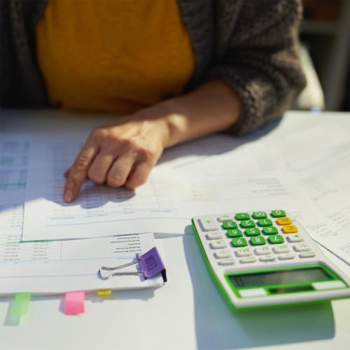 a person looks at paperwork on a desk