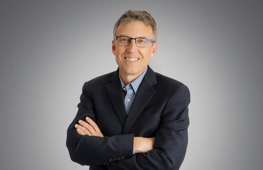 A headshot of Michael Henkenius