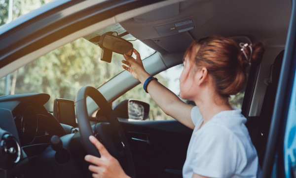 Person checking their rear view mirror.