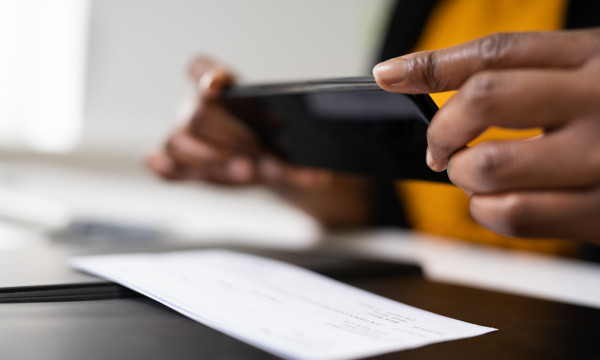 Person taking a photo of their check with their phone.