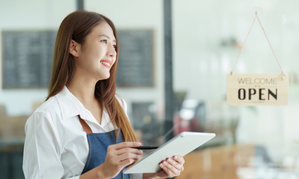 woman business owner smiles