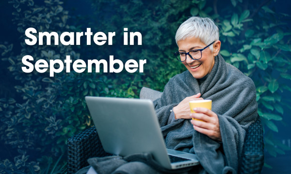 smarter in september woman smiling at computer