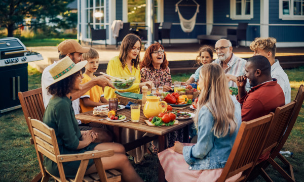 a family sits at a table laughing