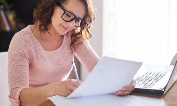 woman looks at a piece of paper