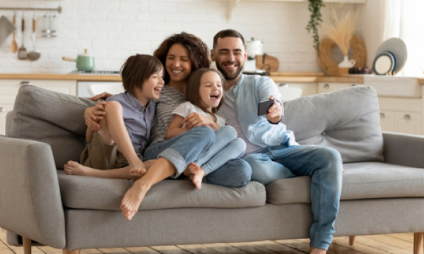 a family sits on their couch