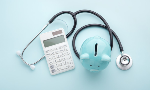 blue piggy bank, calculator, stethoscope 