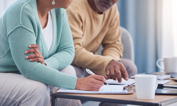 a couple sit down together to review papers