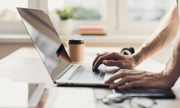 a person uses a laptop on the table