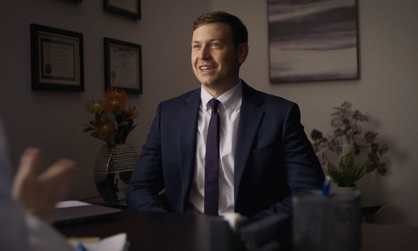 Tyler Hunt sits with a client