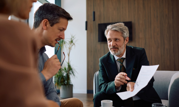 a man and woman talk to a professional businessman 