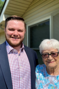 A handsome young man posing with an elderly woman